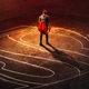 Seg-El (Cameron Cuffe) grasping his grandson’s cape in a poster for Krypton.